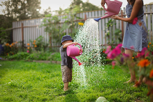 Mom and son watering the garden