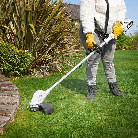 Cordless grass trimmer in use